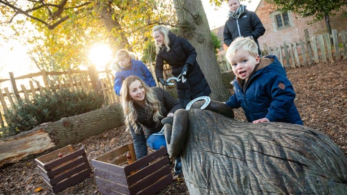 Multi-generational family playing with horseshoes on the trail in Charlecote's Spinney